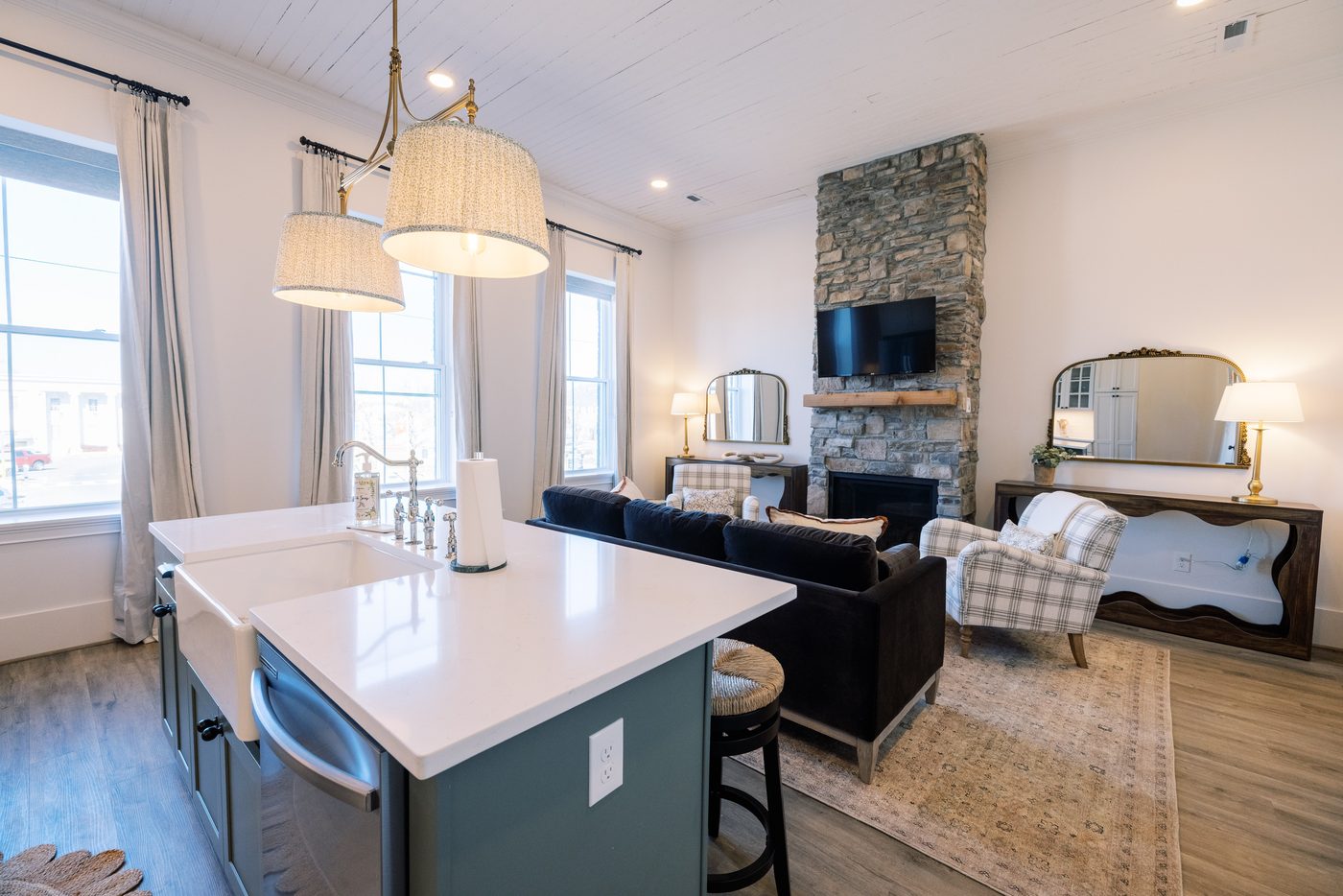Boutique hotel suite — open kitchen and living room with stone fireplace